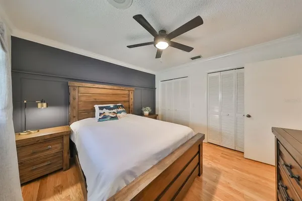 a bathroom with a granite countertop sink a mirror and shower