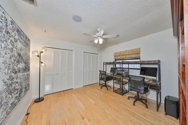 a bedroom with a bed and a ceiling fan