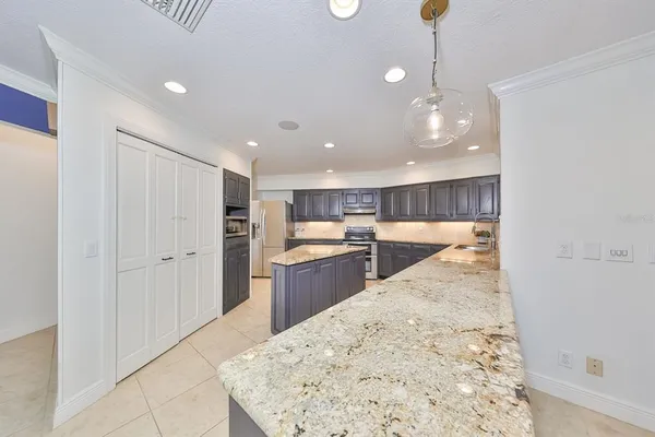 a kitchen with stainless steel appliances kitchen island granite countertop a sink and cabinets