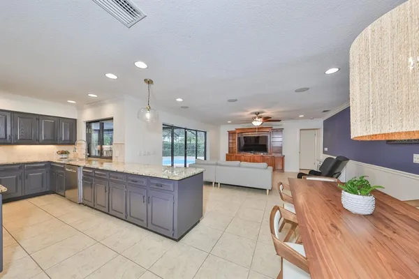 a living room with furniture and a ceiling fan