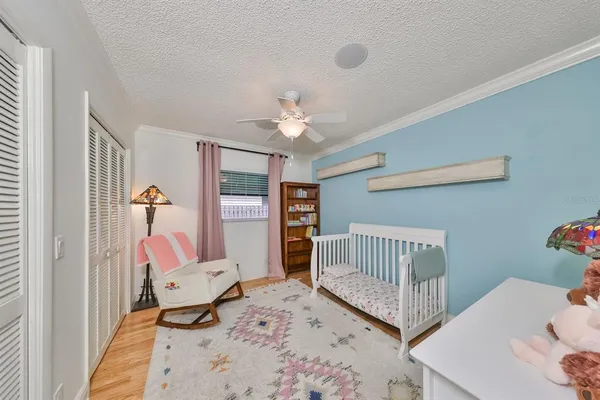 a bedroom with furniture and a large window