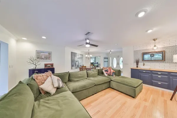 a living room with furniture and a chandelier
