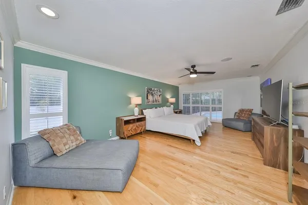a bedroom with furniture and a flat screen tv