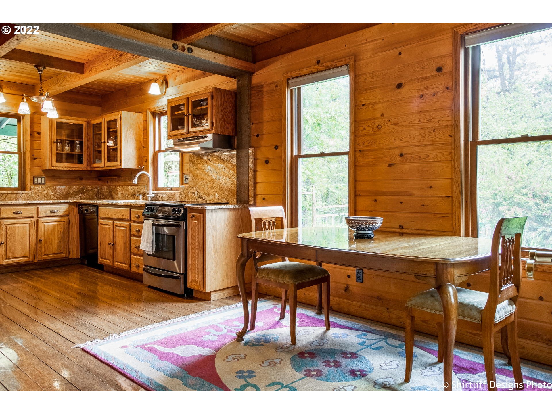 31872 Fox Hollow Road Eugene, OR 97405 - Photo 11 of 32 a kitchen with stainless steel appliances kitchen island granite countertop a stove and a refrigerator