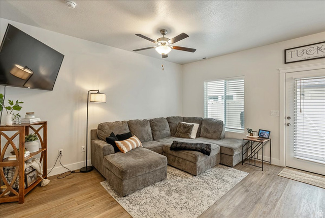 287 North 100th West Morgan, UT 84050 - Photo 7 of 27 Living area featuring light wood-style floors, ceiling fan, and a textured ceiling