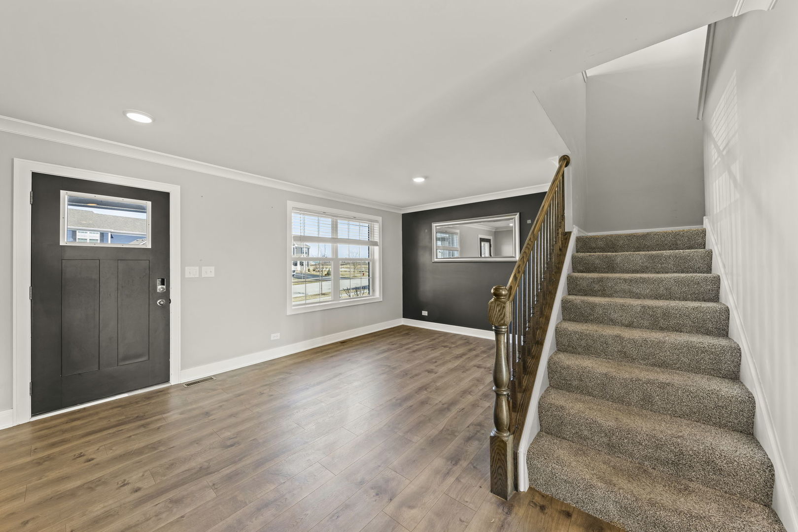 934 Redcliff Road New Lenox, IL 60451 - Photo 3 of 34 a view of an empty room with wooden floor and stairs
