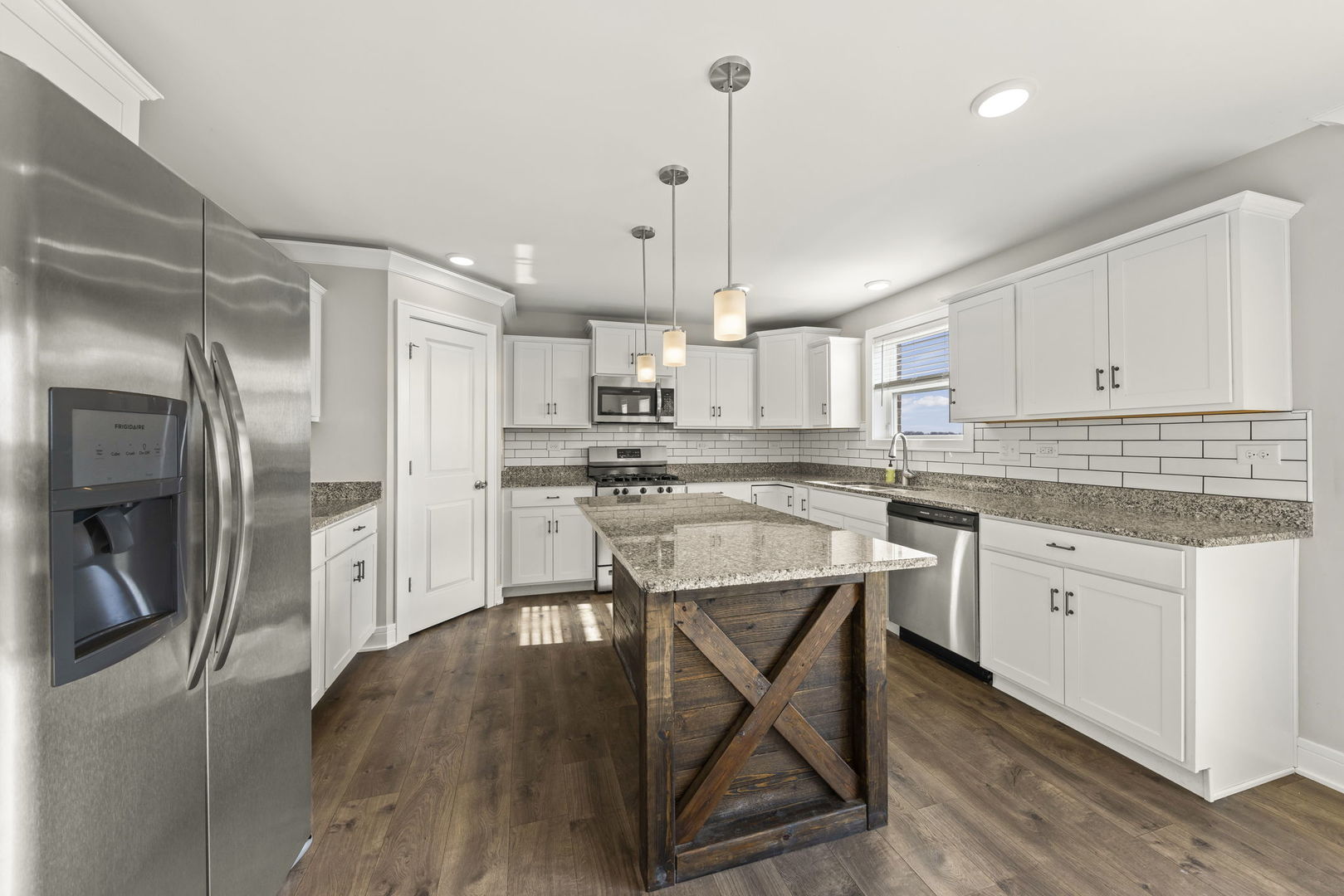 934 Redcliff Road New Lenox, IL 60451 - Photo 7 of 34 a kitchen with stainless steel appliances granite countertop a refrigerator a sink dishwasher a stove and white cabinets with wooden floor