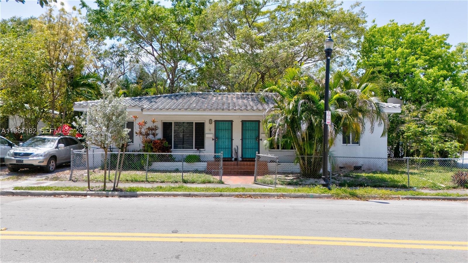 2 Northeast 45th Street Miami, FL 33137 - Photo 1 of 27 a front view of a house with a garden and tree
