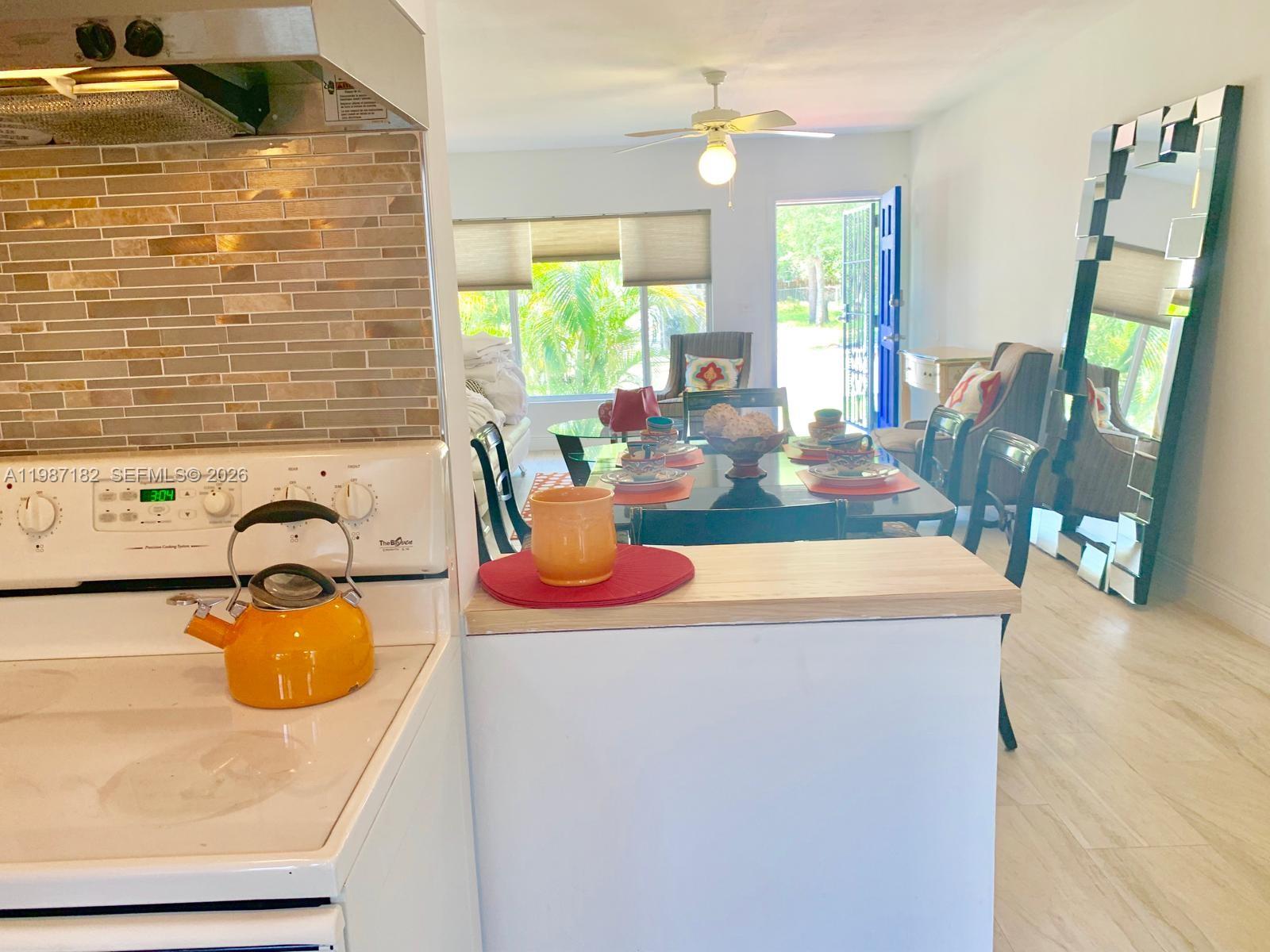 2 Northeast 45th Street Miami, FL 33137 - Photo 12 of 27 a dining table with chairs and window