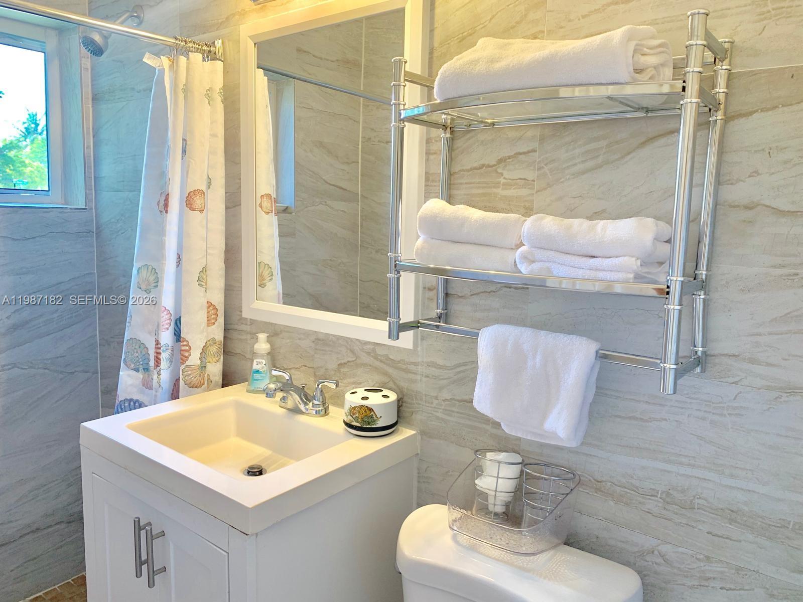 2 Northeast 45th Street Miami, FL 33137 - Photo 16 of 27 a bathroom with a sink and a mirror