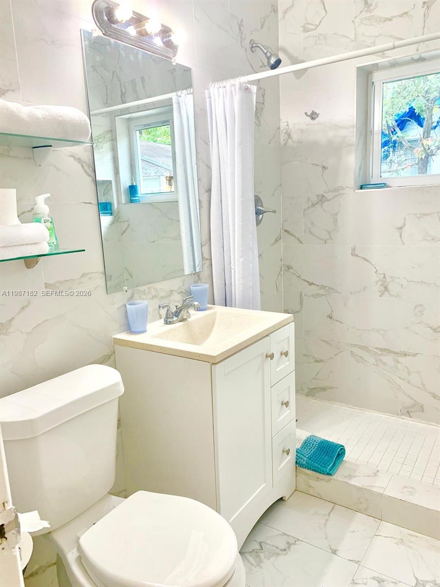 2 Northeast 45th Street Miami, FL 33137 - Photo 21 of 27 a bathroom with a sink toilet and shower