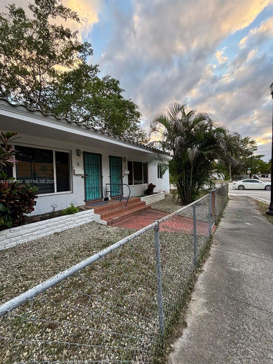 2 Northeast 45th Street Miami, FL 33137 - Photo 3 of 27 a front view of a house with a yard and trees