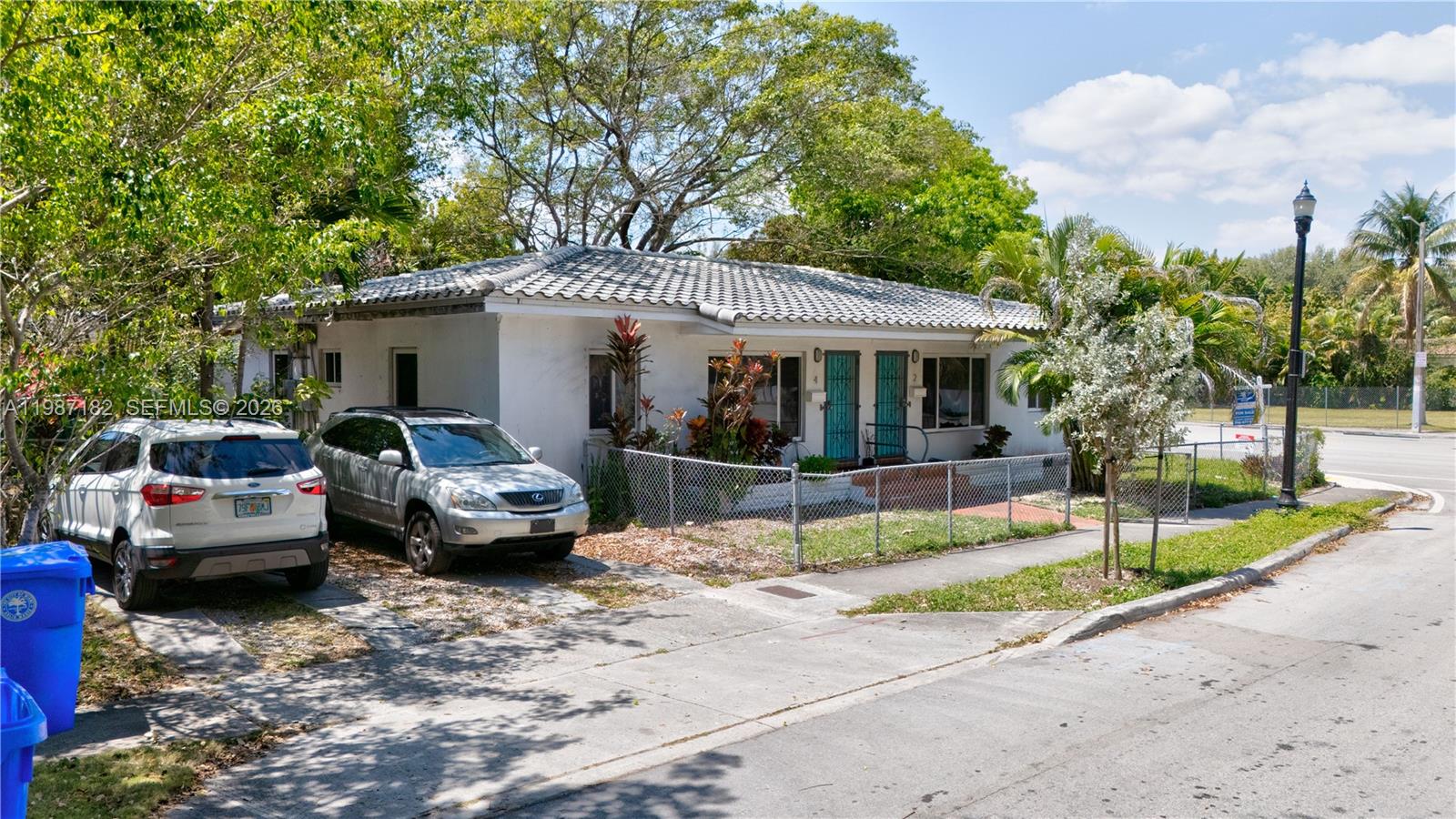 2 Northeast 45th Street Miami, FL 33137 - Photo 5 of 27 a view of a white house with a large tree in front of it
