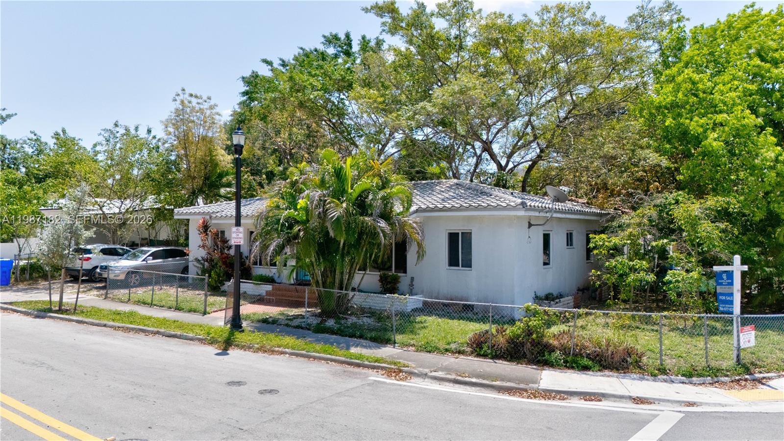 2 Northeast 45th Street Miami, FL 33137 - Photo 8 of 27 a front view of a house with a garden and trees