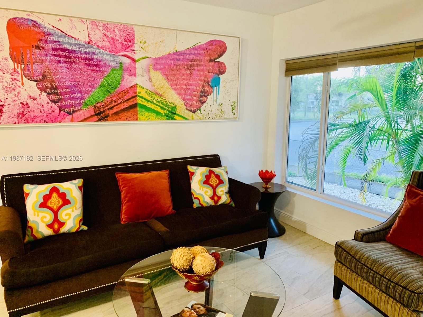 2 Northeast 45th Street Miami, FL 33137 - Photo 9 of 27 a living room with furniture and a flat screen tv