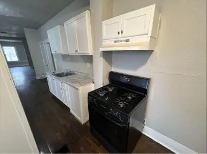 a kitchen with stainless steel appliances a white stove top oven and a sink