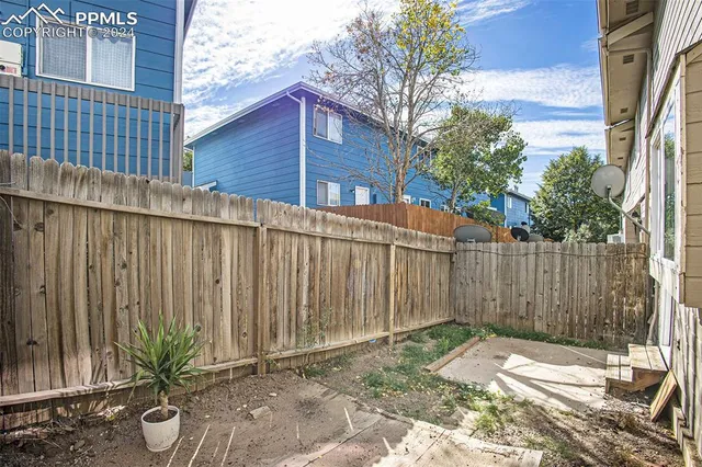 a backyard of a house with plants and trees