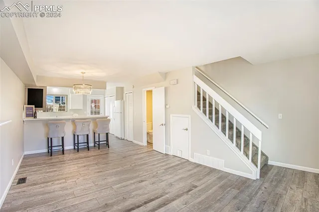 a view of a livingroom with furniture and wooden floor