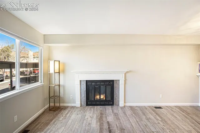 a room with a fireplace and wooden floor