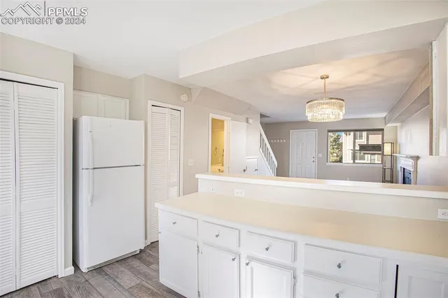 a view of a kitchen with a sink and a refrigerator