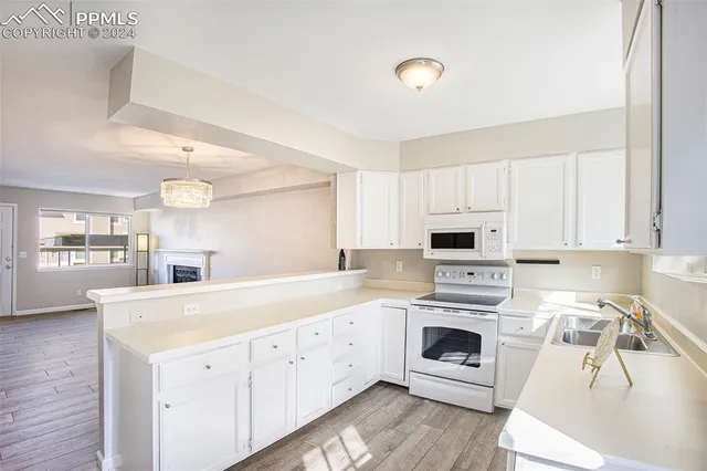 a view of a kitchen with a sink cabinets and wooden floor