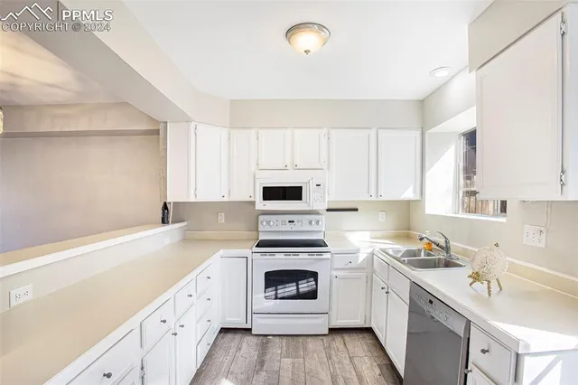 a kitchen with a stove oven and sink