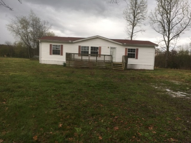 a front view of house with yard and trees