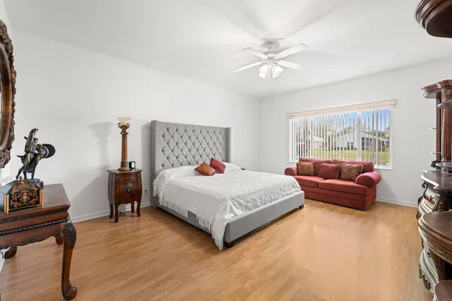 a bedroom with a bed dresser and a window