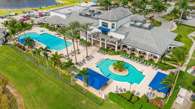 an aerial view of ocean and residential houses with outdoor space