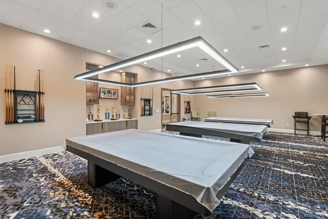 a living room with patio furniture and a book shelf