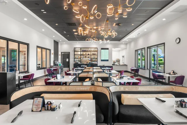 a living room with furniture a rug and a large window