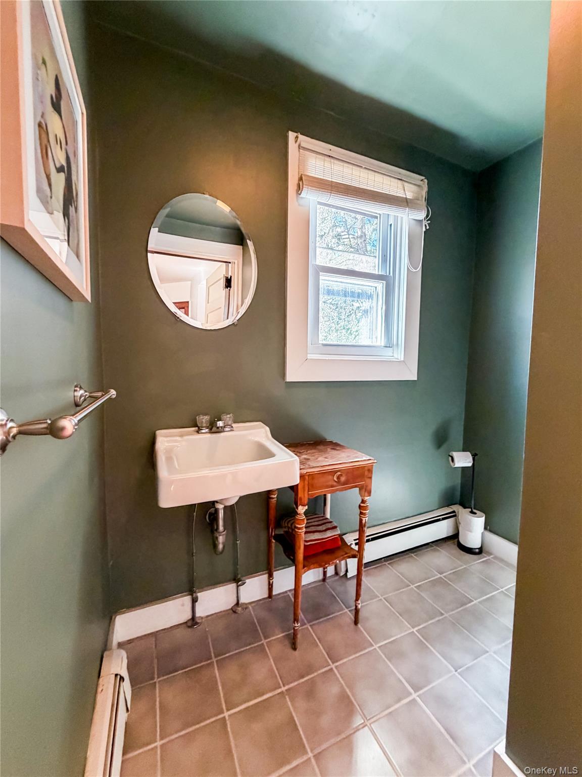 350 Smith Street Peekskill, NY 10566 - Photo 19 of 32 a dining room with a sink and a mirror