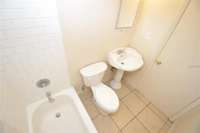 an empty room with a ceiling fan and window