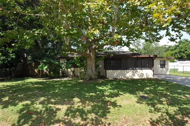a backyard of a house with table and chairs
