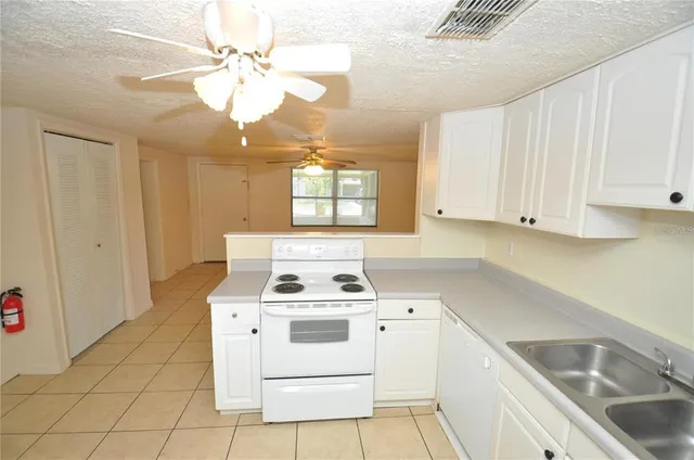 a kitchen with a stove cabinets and a sink