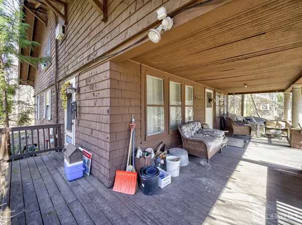 a outdoor space with patio the couches and a potted plant on a wooden floor