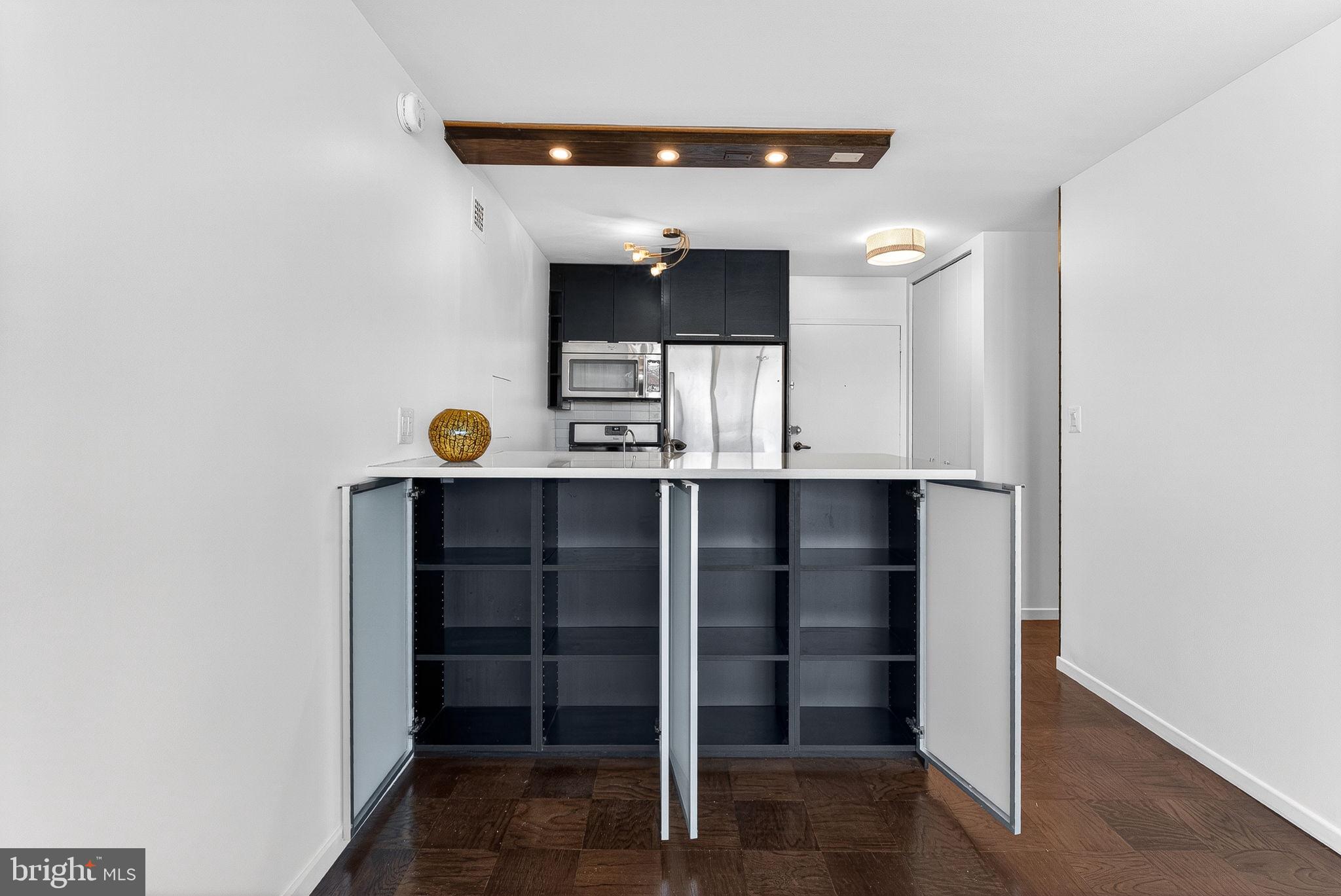 2030 F Street Northwest, Unit 606 Washington, DC 20006 - Photo 9 of 29 Abundant storage in cabinets facing living area