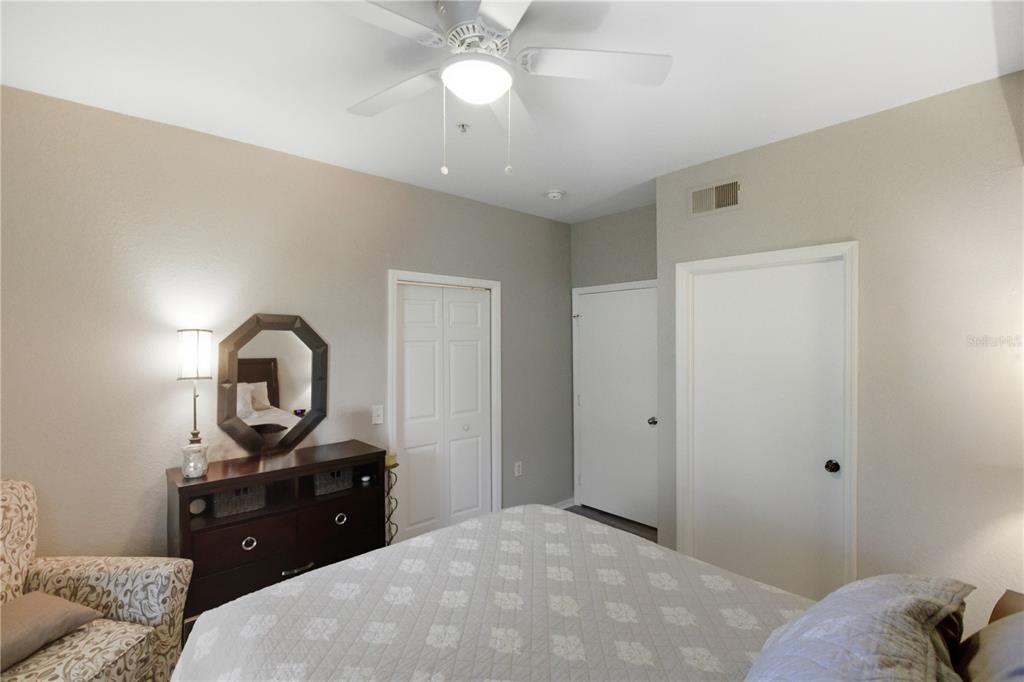 5122 Northridge Road, Unit 107 Sarasota, FL 34238 - Photo 16 of 36 a bedroom with a bed and a dresser