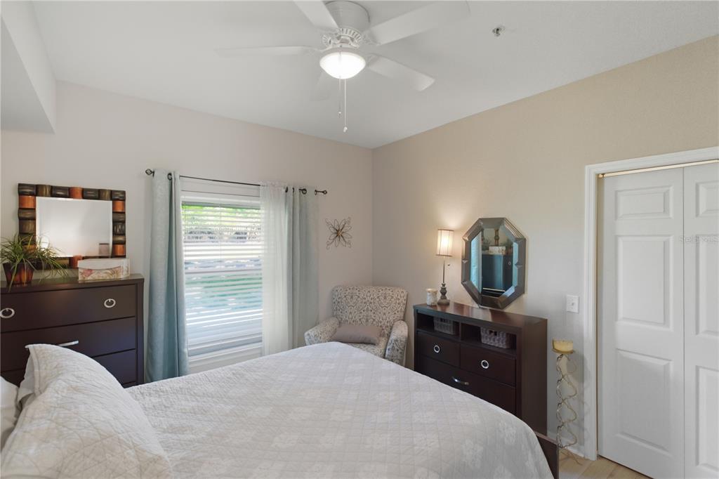5122 Northridge Road, Unit 107 Sarasota, FL 34238 - Photo 17 of 36 a bedroom with a bed and a tv on table