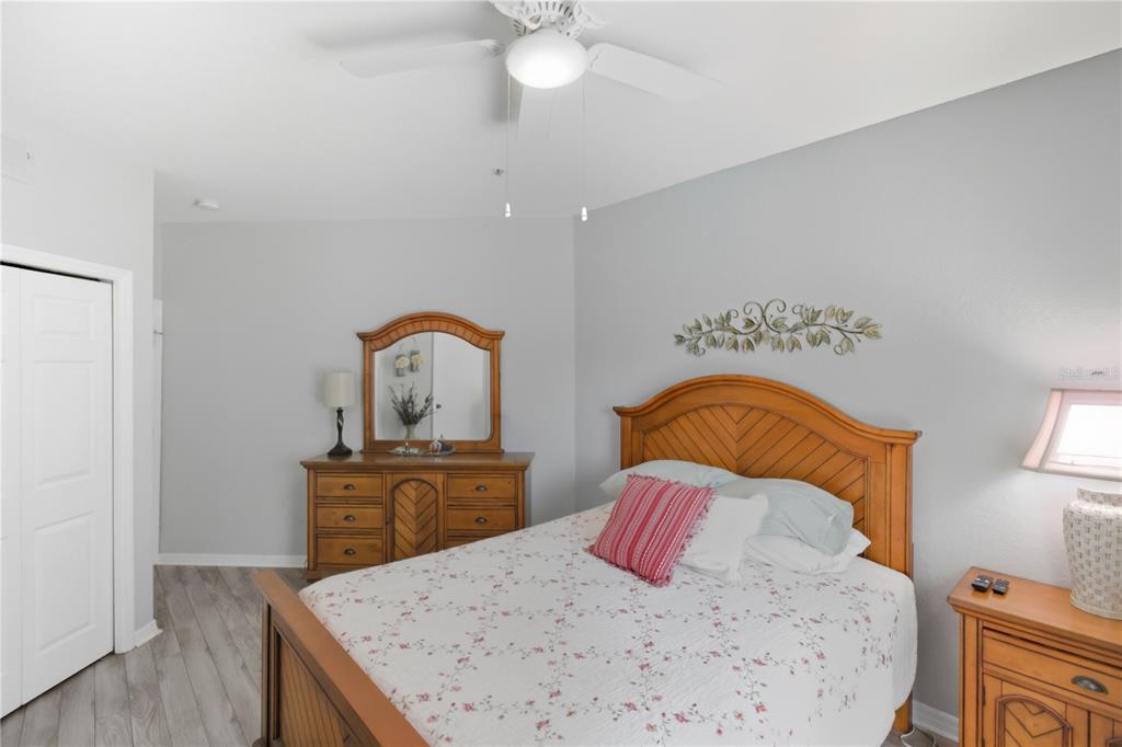 5122 Northridge Road, Unit 107 Sarasota, FL 34238 - Photo 20 of 36 a bedroom with a bed and a dresser in it