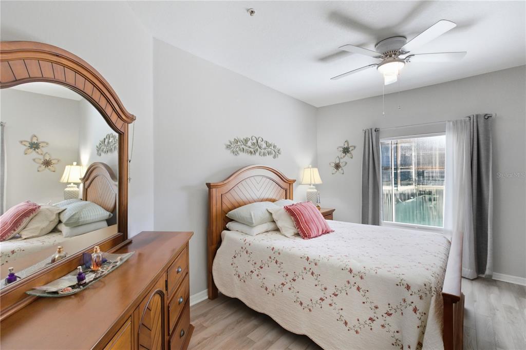 5122 Northridge Road, Unit 107 Sarasota, FL 34238 - Photo 23 of 36 a bedroom with a bed and a dresser