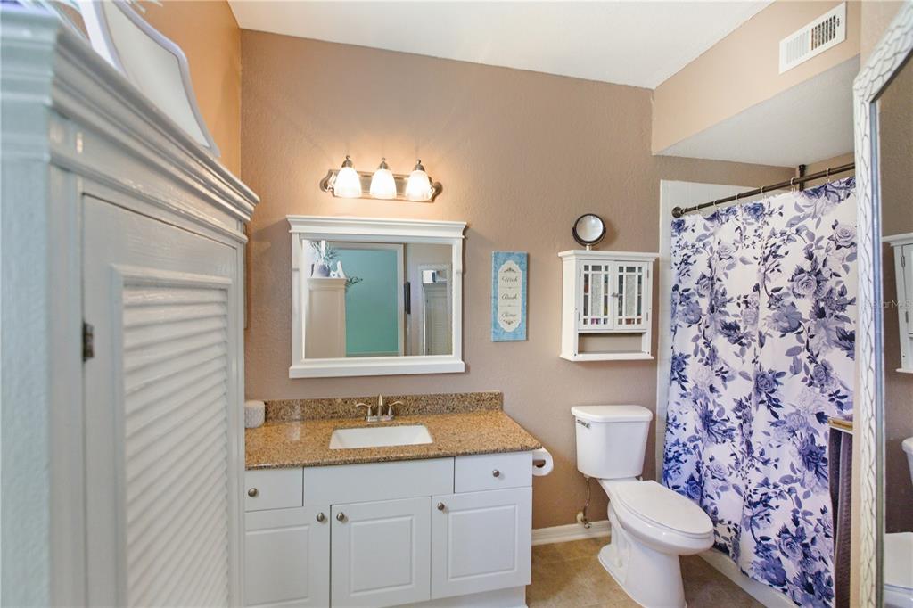 5122 Northridge Road, Unit 107 Sarasota, FL 34238 - Photo 28 of 36 a bathroom with a granite countertop sink and a toilet