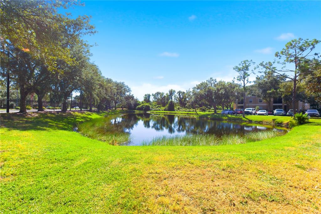 5122 Northridge Road, Unit 107 Sarasota, FL 34238 - Photo 29 of 36 a view of a lake with houses