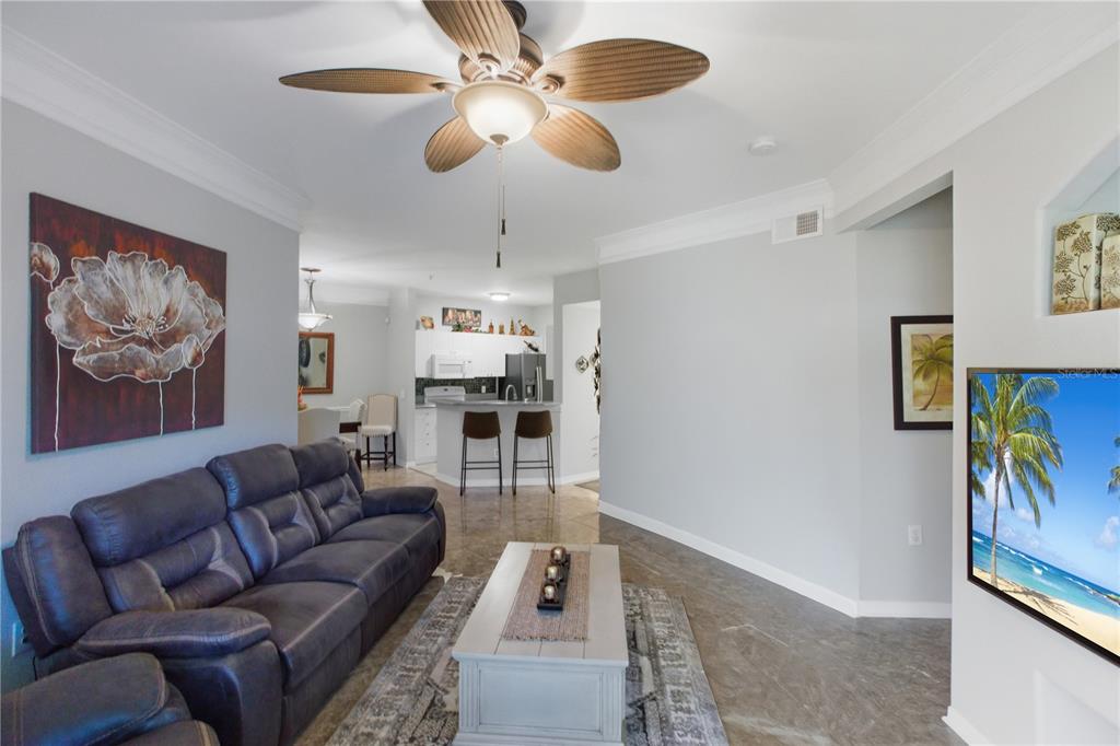 5122 Northridge Road, Unit 107 Sarasota, FL 34238 - Photo 3 of 36 a living room with furniture and a flat screen tv