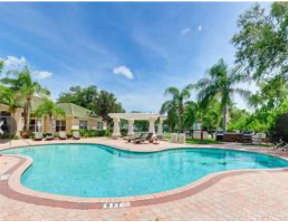 5122 Northridge Road, Unit 107 Sarasota, FL 34238 - Photo 32 of 36 a view of a house with outdoor space patio and trees