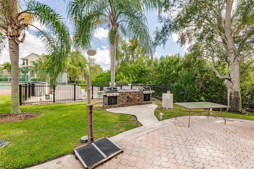 5122 Northridge Road, Unit 107 Sarasota, FL 34238 - Photo 35 of 36 a view of a swimming pool with a table and chairs