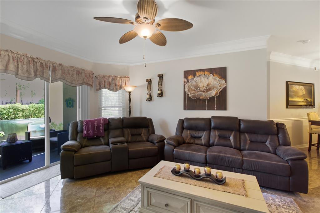 5122 Northridge Road, Unit 107 Sarasota, FL 34238 - Photo 4 of 36 a living room with furniture ceiling fan and a window