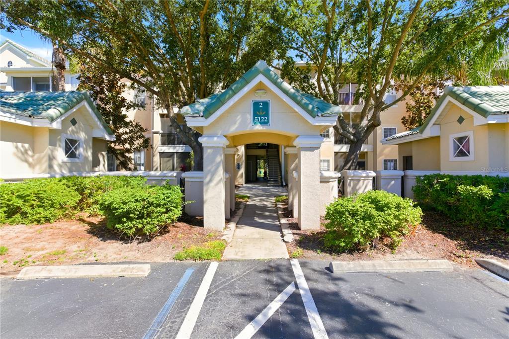 5122 Northridge Road, Unit 107 Sarasota, FL 34238 - Photo 6 of 36 a front view of a house with garden