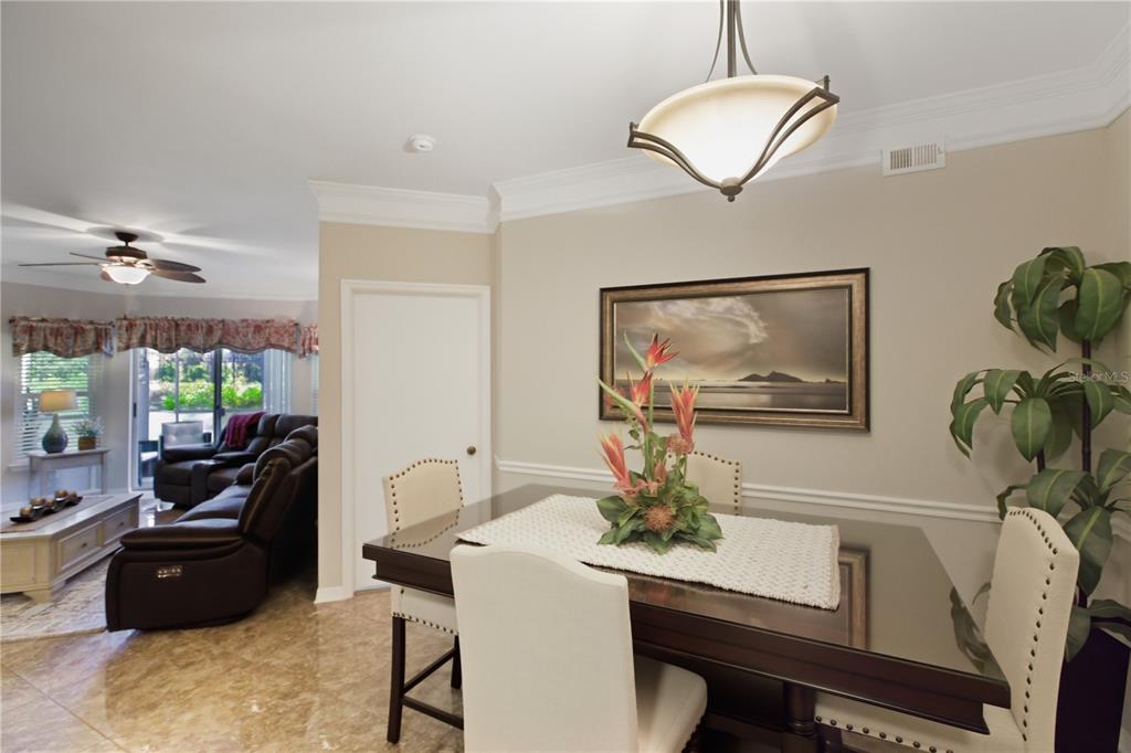5122 Northridge Road, Unit 107 Sarasota, FL 34238 - Photo 7 of 36 a living room with furniture and a flat screen tv