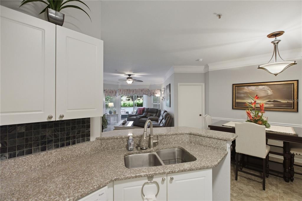 5122 Northridge Road, Unit 107 Sarasota, FL 34238 - Photo 9 of 36 a kitchen with a sink cabinets and window